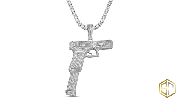 Iced Out Gun Pendant by SOFT PARADISE featuring cubic zirconia stones on a detailed silver-tone chain.