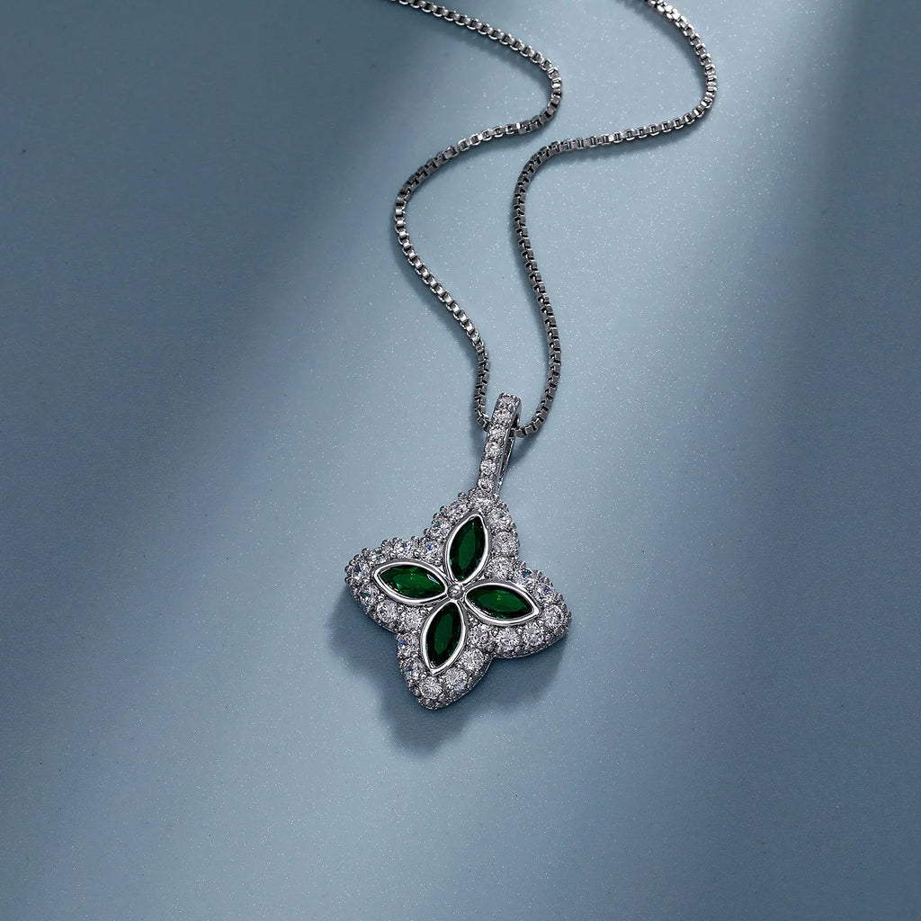 Silver necklace with a green gemstone pendant on a blue background