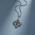 Silver necklace with a green gemstone pendant on a blue background