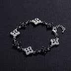 Four-Leaf Clover Bracelet in silver-tone with pavé crystals and black bead accents.