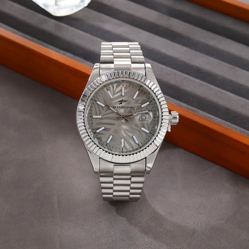 Silver watch with a detailed face on a gray surface