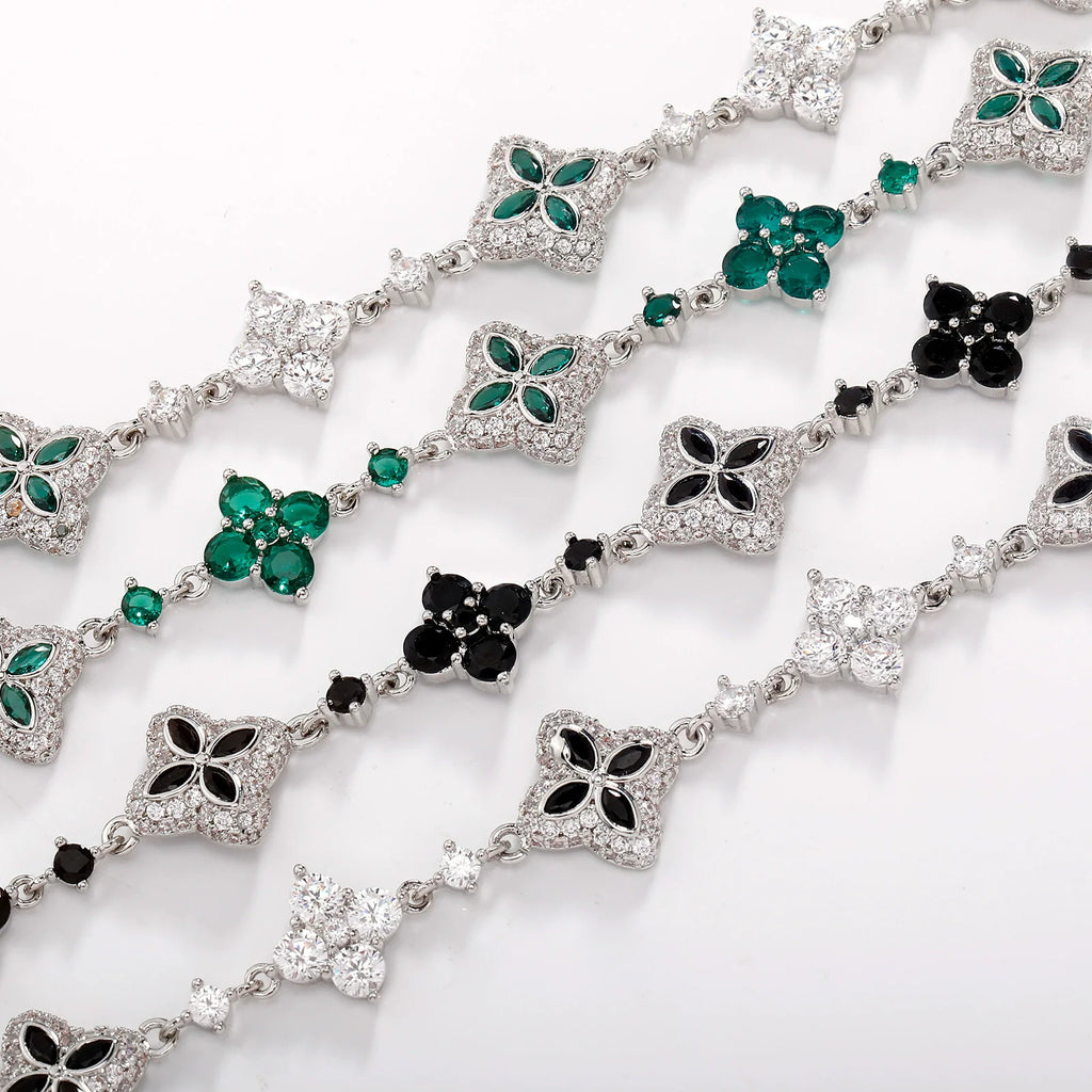Four-Leaf Clover Bracelet with silver-tone links and crystal-clad four-leaf motifs in green, black, and clear stones