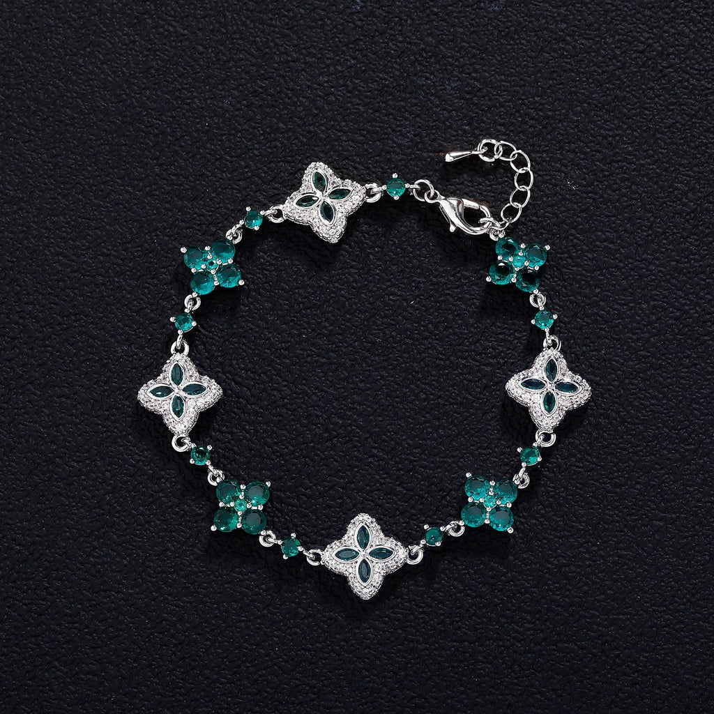 Four-Leaf Clover Bracelet with emerald-green stones in silver-tone setting and adjustable chain.