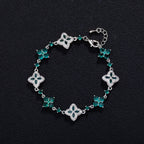 Four-Leaf Clover Bracelet with emerald-green stones in silver-tone setting and adjustable chain.